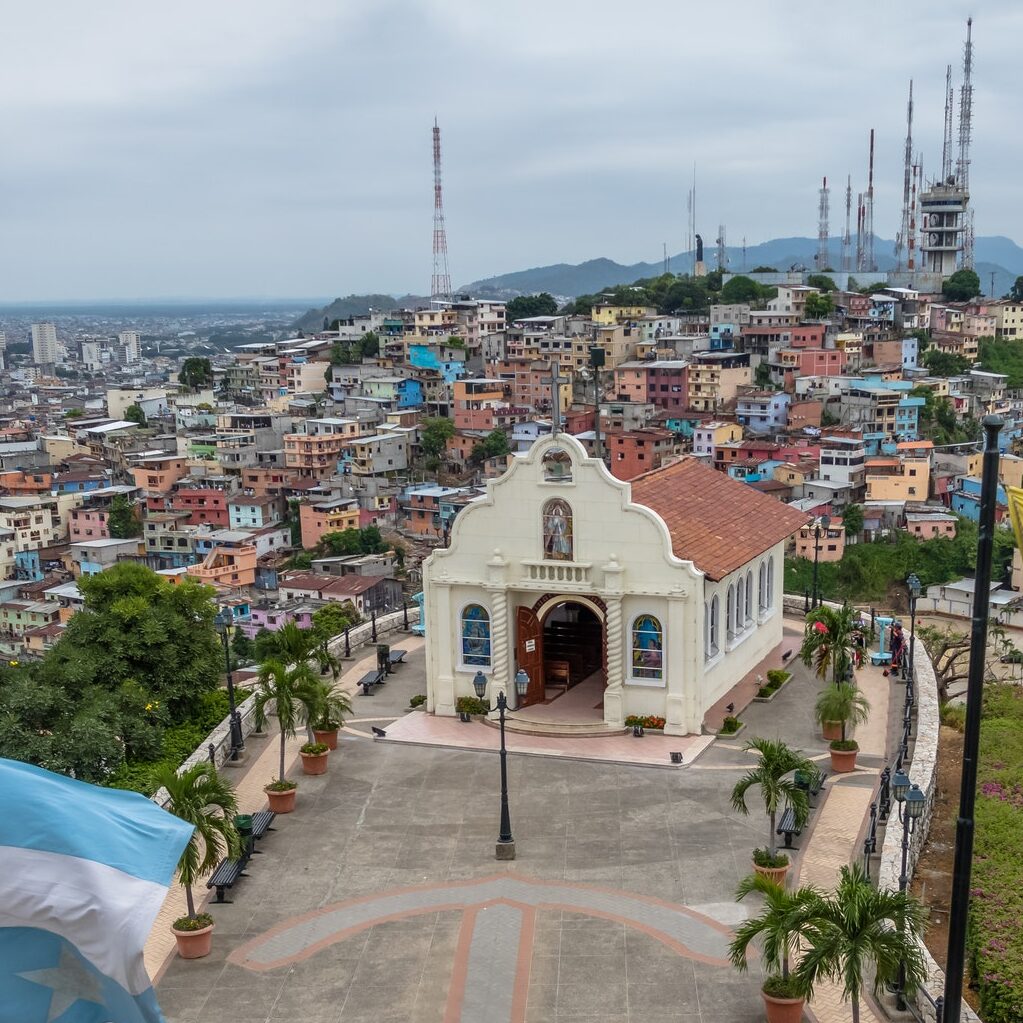 Santa Ana Church on top of Santa Ana hill with Ecuador and city flags - Guayaquil, Ecuador